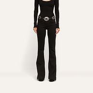 Her Story Flare Jean in black, low-rise, slim-cut, worn with a long-sleeved black top and a silver western-style belt.