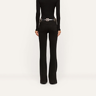Back view of black slim-cut Her Story Flare Jean worn with a black long-sleeve top and a silver-buckled belt.