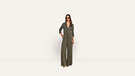 A woman wearing a long-sleeved olive green jumpsuit and sunglasses poses against a plain background.