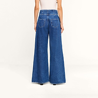 Back view of Sonja Corset Jean, ultra high-rise, wide-leg blue jeans featuring a corset-style waistband.