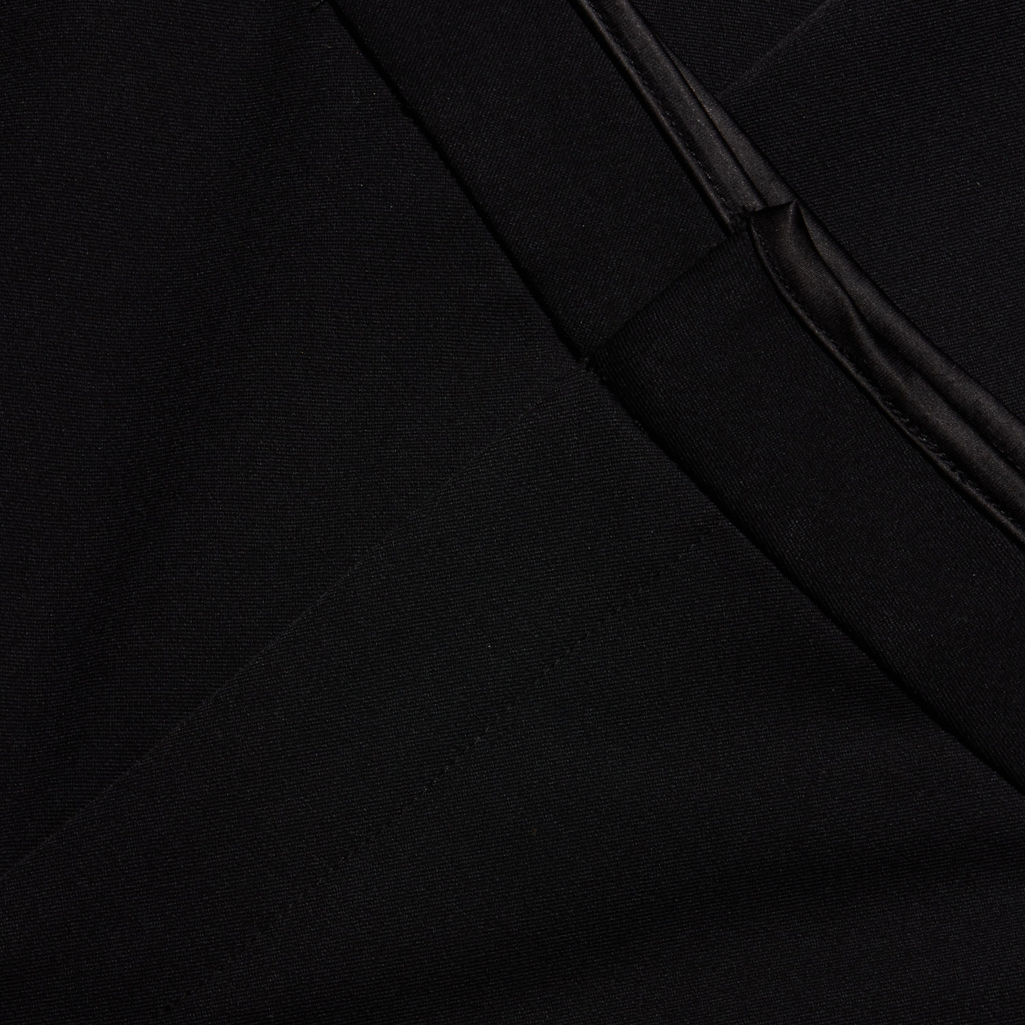 Close-up of slim-straight black Rebel Trouser featuring a pocket with a smooth, satin-look trim.