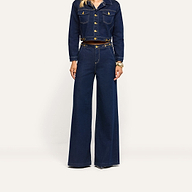 Person wearing a dark wash denim cropped jacket with gold buttons and matching Jules Wide-Leg Jean.