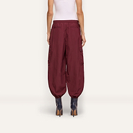 Back view of a person wearing dark red Monrose Nylon Jogger cargo pants with side utility pockets and cinched cuffs, paired with dark heeled boots.