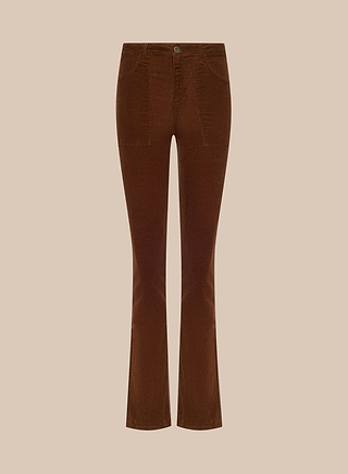 The Saffia Corduroy Pant is a high-rise brown stretch corduroy style, featuring front pockets and a button closure in a slim-straight jean silhouette, shown against a plain beige background.