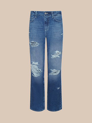 A pair of Zelda Slouchy Straight Jeans in a medium indigo wash, showcasing a relaxed straight-leg fit with prominent rips and frayed detailing on the thighs and knees, displayed against a simple beige background.