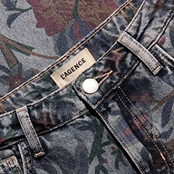 Close-up of the waistband, button, and brand label of the slim stovepipe boho-print Gianna Stovepipe Jean.