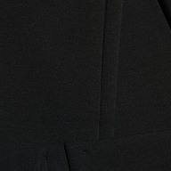 Close-up of black Enid Stirrup Legging scuba knit leggings featuring a vertical seam.
