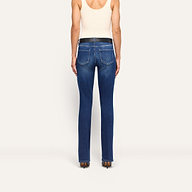 Back view of a person wearing Kezia Bootcut Jean in dark-wash with a low rise and black belt.