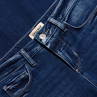Close-up of the waistband, button closure, and pockets of the dark blue stretch denim Kezia Bootcut Jean.