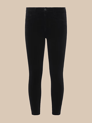 The Margot Cropped Skinny Jean in black stretch denim is showcased against a plain beige background, front-facing with slightly apart legs, and cropped above the ankles.