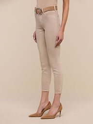 Model wearing tan high heels, Margot Cropped Skinny Jean in beige with a contoured waistband, a beige belt, and a beige sleeveless top. The photo is taken against a plain white background, showing the model from shoulder to feet.