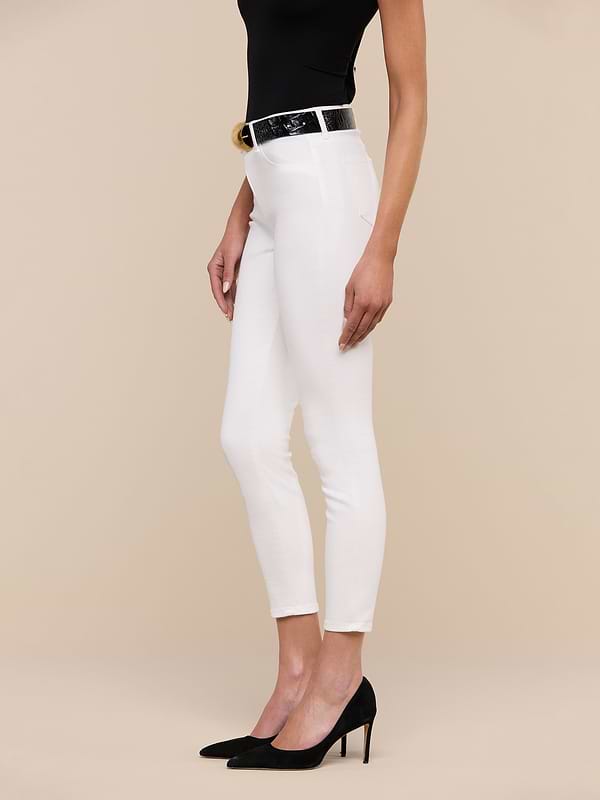 A woman in a black sleeveless top, black belt, black high heels, and the Margot Cropped Skinny Jean stands against a plain white background, shown from mid-shoulder to feet.