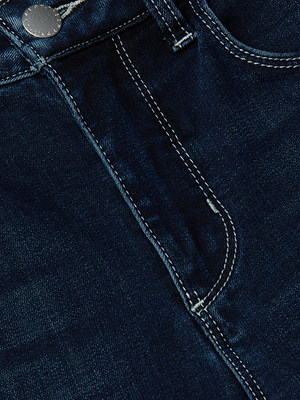 Close-up of the top section of the L'AGENCE Margot Cropped Skinny Jean in dark blue stretch denim, highlighting the front pocket, waistband, metal button, and double stitching details.