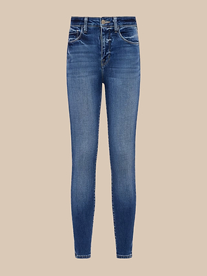 The Marguerite Skinny Jean is a high-rise, blue stretch denim with a slightly faded wash, button and zip closure, and front and back pockets, shown against a beige background.
