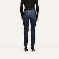 Back view of Marguerite Skinny Jean high-rise skinny jeans worn with a black top and black high-heeled pumps.