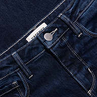 Close-up of Marguerite Skinny Jean high-rise dark blue stretch denim, showing the waistband, silver metal button, and contrast stitching.
