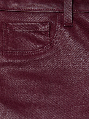 Close-up of the front pocket and belt loop of the L'AGENCE Marguerite Coated Skinny Jean, showcasing its maroon fabric texture and precise stitching details.