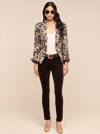 A woman stands facing forward against a neutral background wearing sunglasses, a patterned blazer, a cream top, beige heels, and the Marguerite Velvet Skinny Jean in stretch velvet.