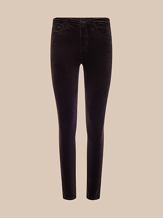 Marguerite Velvet Skinny Jean in dark brown, featuring a high rise, button and zip closure, front and back pockets, and a slim, tapered fit, displayed against a beige background.