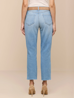 A person shown from the back wears the Sada Cropped Slim-Leg Jean in light wash with raw hems and a white top, paired with tan heeled shoes against a beige background.