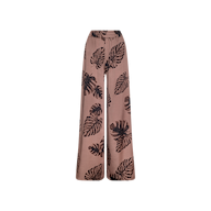 Lillian Satin Pant: Ultra-wide, high-waisted satin trousers in light brown with a black palm leaf print, displayed against a plain white background.