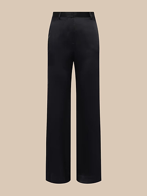 The Pilar Silk Wide-Leg Pant features a high waist, belt loops, and a straight tailored fit in black silk, shown against a beige background.