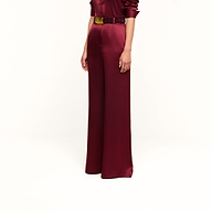A person wearing the Pilar Silk Wide-Leg Pant in burgundy, styled with a matching belt and long-sleeve top, standing against a plain white background.