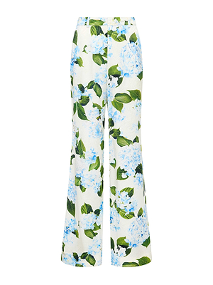 The L'AGENCE Sale Pilar Satin Wide-Leg Pant features a high waist, front zip closure, and elegant satin jacquard texture with blue and white hydrangea florals and lush green leaves on a light background.
