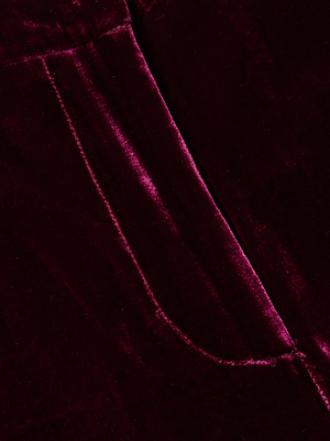 Close-up of L'AGENCE Pilar Velvet Wide-Leg Pant in dark red, highlighting the silk-infused velvet fabric with a visible seam and pocket, featuring the soft texture and subtle sheen signature to high-rise, wide-leg designs.