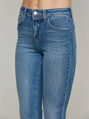 A model wears L'AGENCE's Ruth Straight-Leg Jean—a high-rise, straight-leg style in classic stretch denim with front pockets and a button closure—shown from waist to mid-thigh against a plain background.