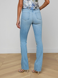 A person wearing the Ruth Straight-Leg Jean, a floral sleeveless top, and heeled sandals is shown from the back against a plain white background.