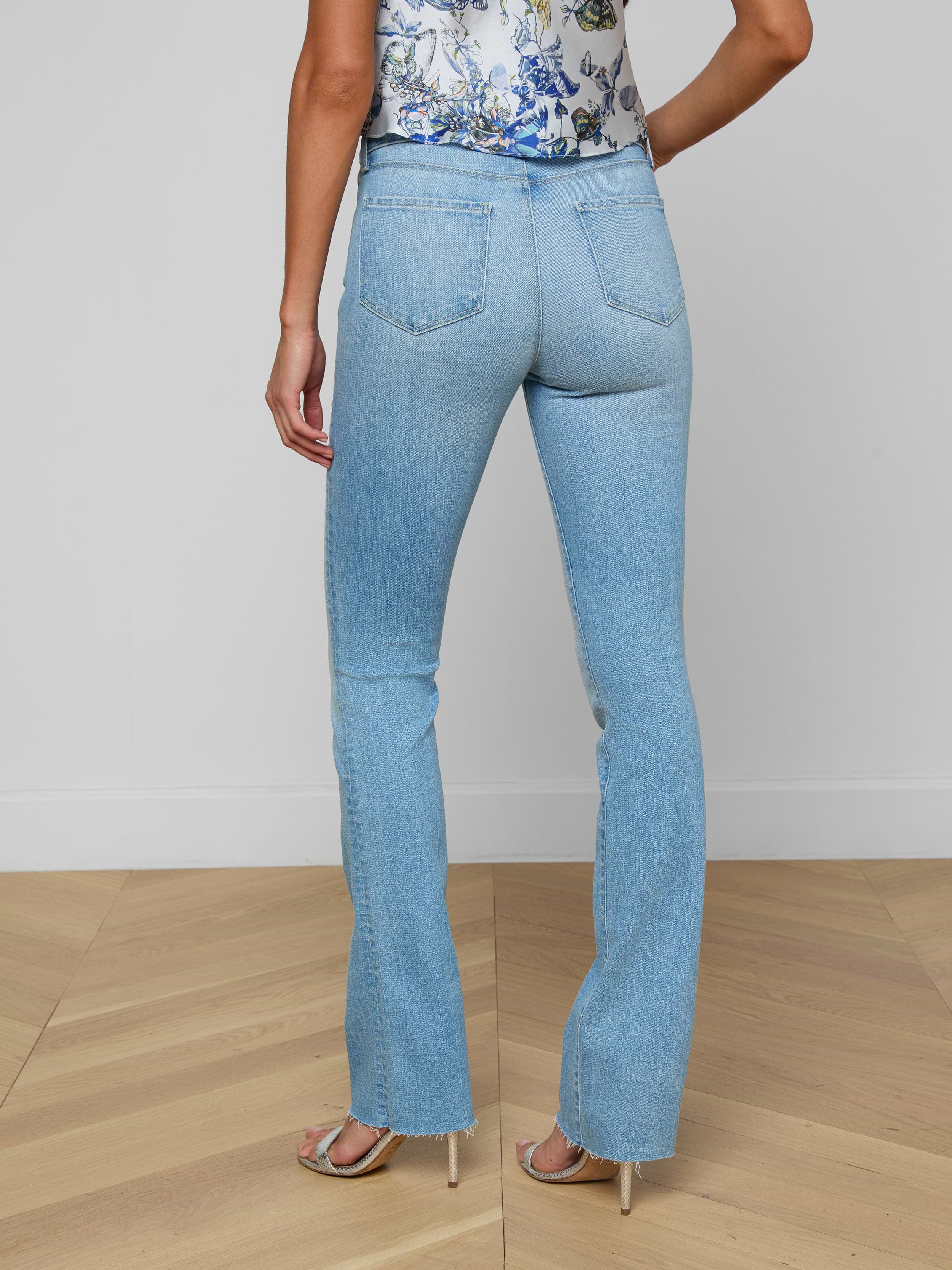 A person wearing the Ruth Straight-Leg Jean, a floral sleeveless top, and heeled sandals is shown from the back against a plain white background.