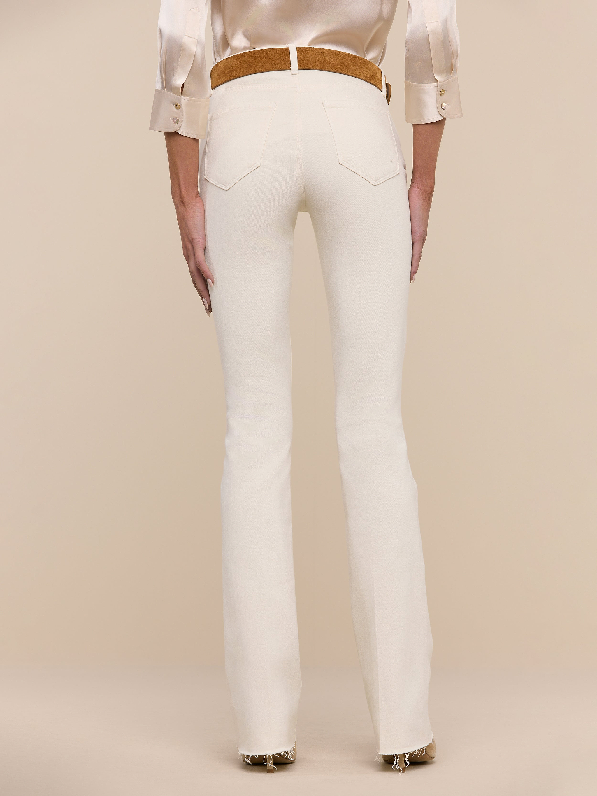 Person wearing Ruth Straight-Leg Jean in vintage white with a tan belt, standing against a plain white background, shown from the back.
