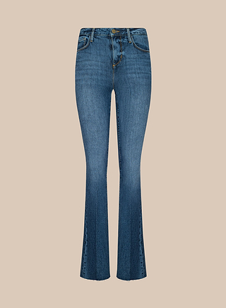 The Ruth Straight-Leg Jean, crafted from high-waisted blue stretch denim with front pockets and straight legs, is displayed against a plain beige background.