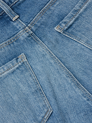 Close-up view of the back of L’AGENCE Ruth Straight-Leg Jean in blue stretch denim, featuring two pockets, visible stitching, and fabric texture.