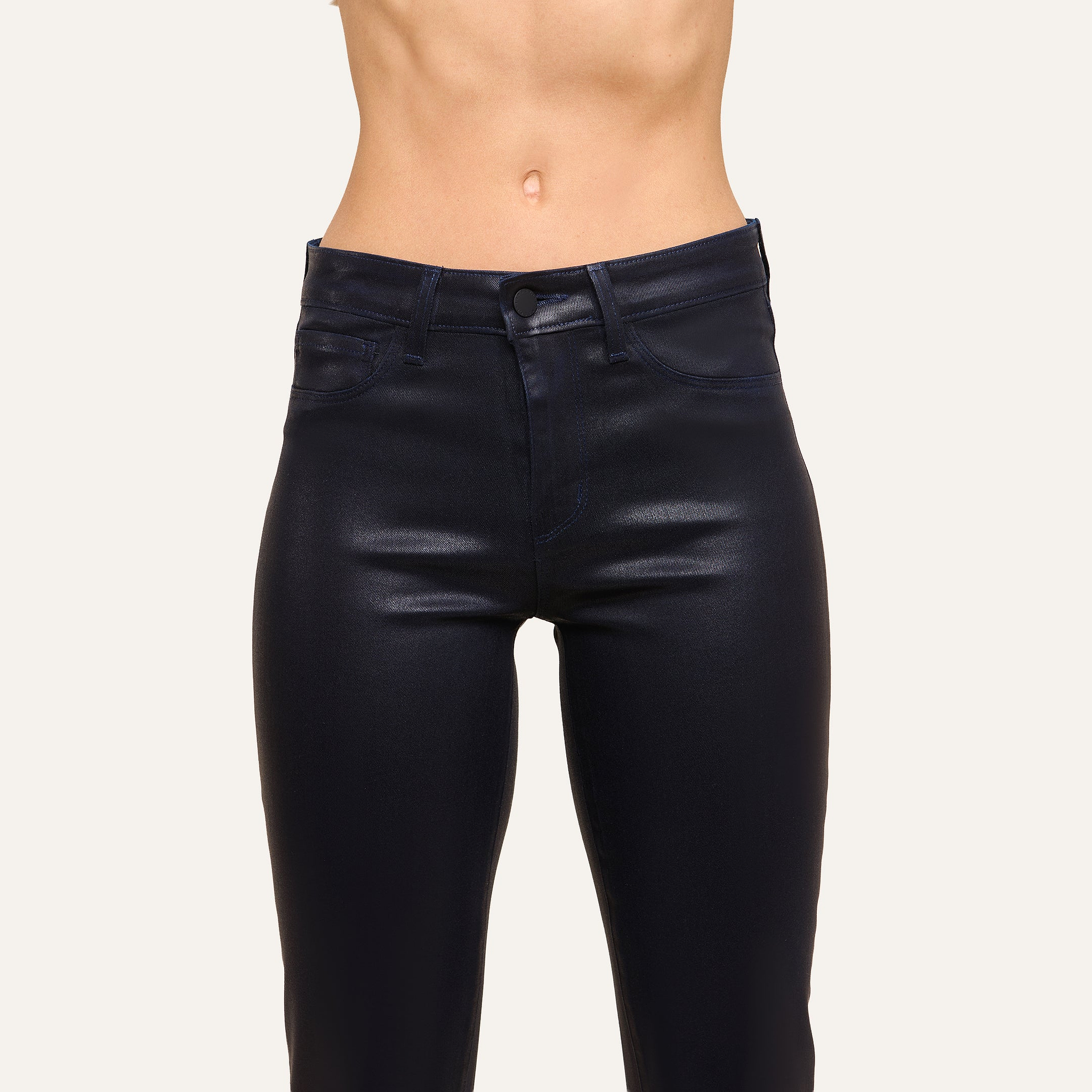 A person wears the Ruth Coated Straight-Leg Jean in black, high-waisted style, shown from waist to mid-thigh against a plain background.