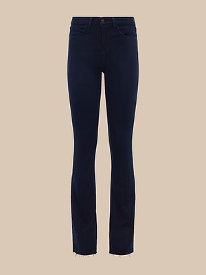 The Ruth Straight-Leg Jean is a dark blue, fitted jean in an ultra dark indigo wash with button and zip closure, front and back pockets, and unfinished frayed hems, displayed on a plain beige background.