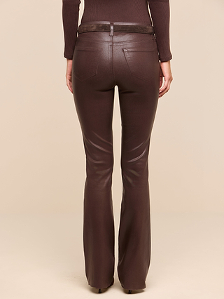 A person wearing the Ruth Coated Straight-Leg Jean in brown, styled with a matching brown top and belt, is shown from the back against a plain beige background.