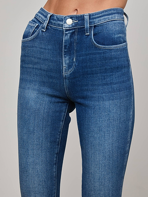 A person models the L'AGENCE Ruth Straight-Leg Jean, featuring a high waist, front pockets, and button closure, shown from waist to mid-thigh against a plain background.