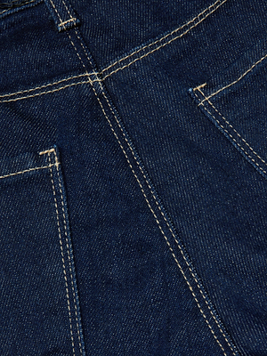 Close-up of dark wash denim with yellow stitching and parts of two front pockets from the Ruth Straight-Leg Jean by L'AGENCE.