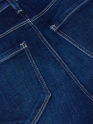 Close-up of the back of L'AGENCE Ruth Straight-Leg Jean in indigo wash, featuring two rear pockets with white stitching.