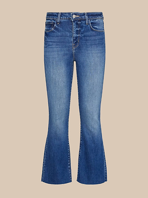 The Kendra Cropped Flare Jean features premium stretch denim in blue, sustainable recycled fibers, front button and zipper closure, classic five-pocket design, and is shown against a neutral beige background.