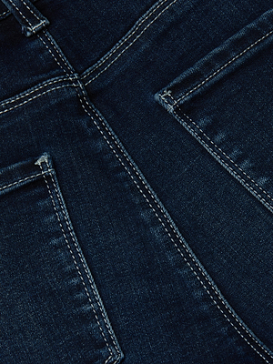 Close-up of the back of L'AGENCE Kendra Cropped Flare Jean in dark wash super stretch denim, featuring two back pockets with white stitching and textured fabric.