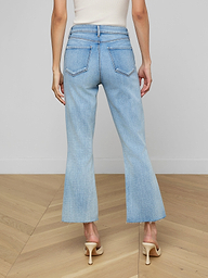 A person is shown from the back wearing the Kendra Cropped Flare Jean in a light wash, paired with a brown sleeveless top and beige heeled shoes, standing against a plain white background.