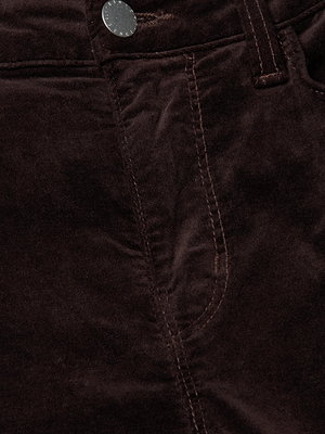 Close-up of Stevie Velvet Jean in coffee bean brown, highlighting the front pocket, waistband, metal button, and visible stitching details.