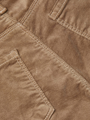 Close-up of tan cappuccino velvet fabric with visible stitching and two overlapping rectangular pockets, highlighting the Stevie Velvet Jean.