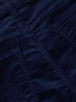 Close-up of the Stevie Velvet Jean by L'AGENCE in dark blue stretch velvet, highlighting visible stitching, straight leg design, classic fit, soft texture, and luxurious material.