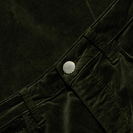 Close-up of the Stevie Velvet Jean in dark green stretch velvet, highlighting the high-rise waistband, belt loops, silver button, and a glimpse of the front pocket.