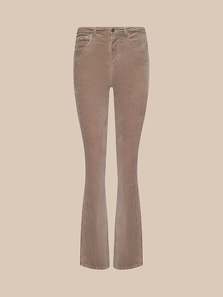 The Stevie Velvet Jean, shown on a plain beige background, features light brown corduroy fabric with a button and zip closure, front and back pockets, and slightly flared legs for a classic look.