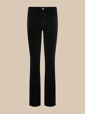The Stevie Velvet Jean is a pair of black slim straight-leg jeans with front and back pockets, button closure, and belt loops, shown against a beige background.